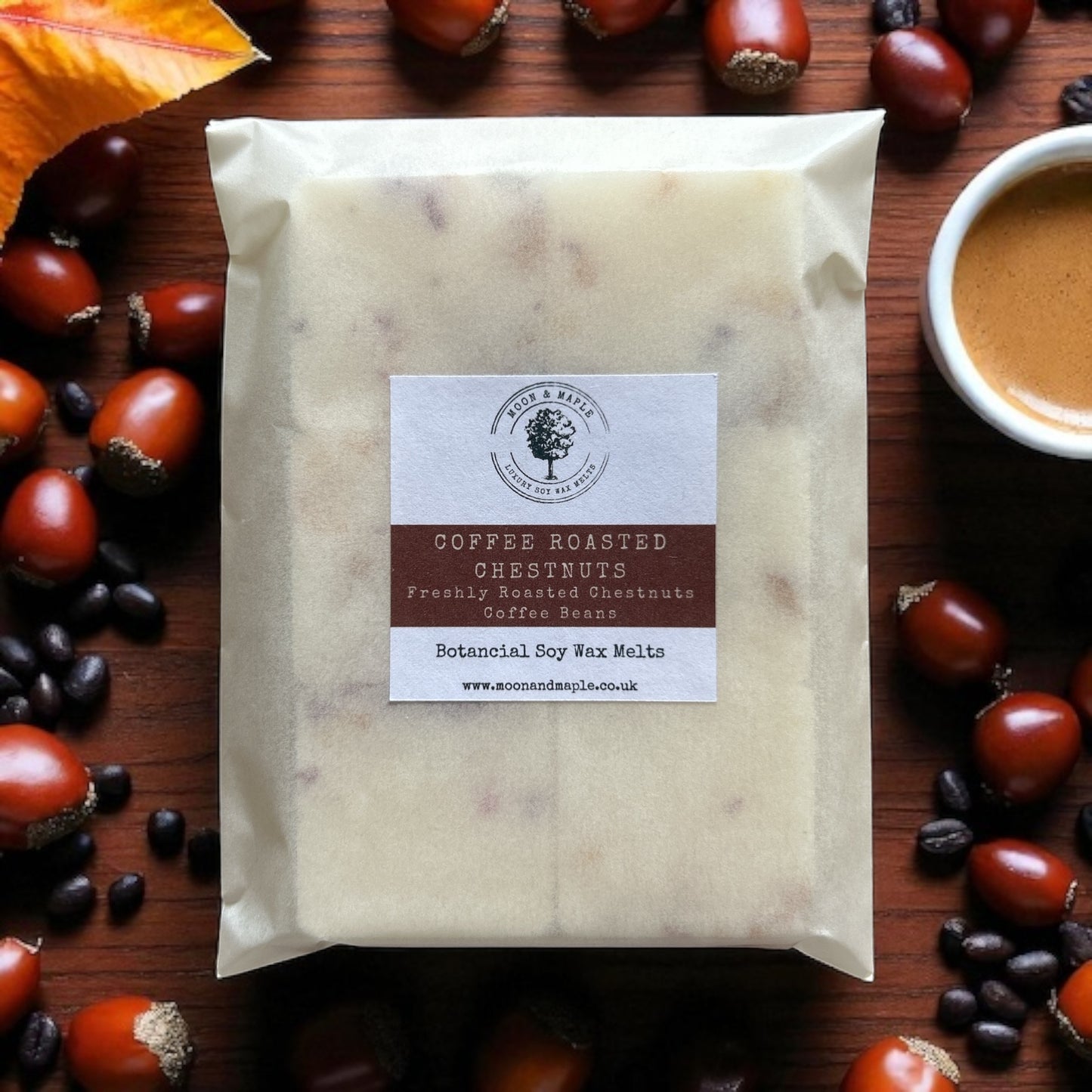 Packaged coffee roasted chestnuts wax melts with a label on a wooden surface with chestnuts and a cup of coffee.
