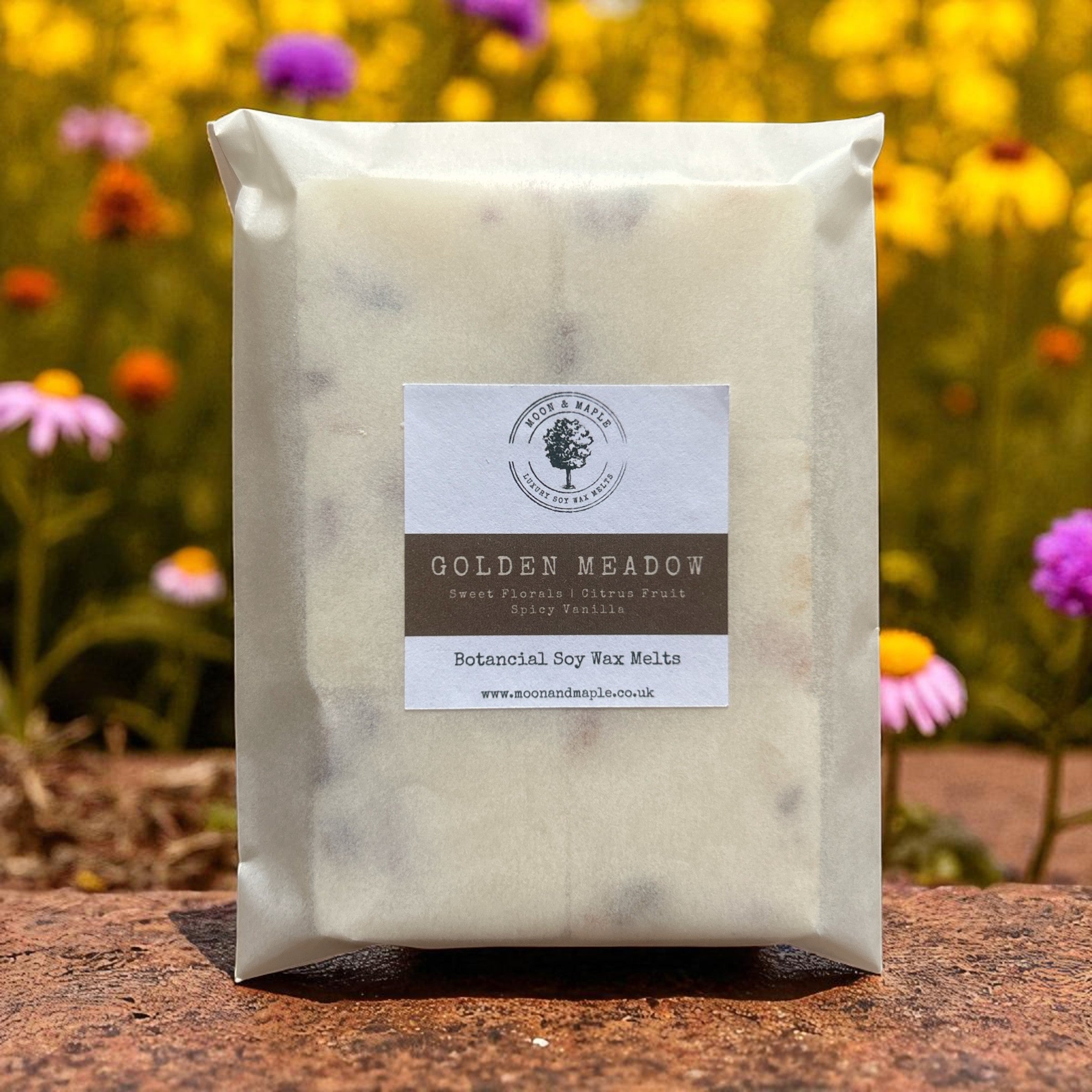 Packaged soy wax melts with a label against a natural background with flowers