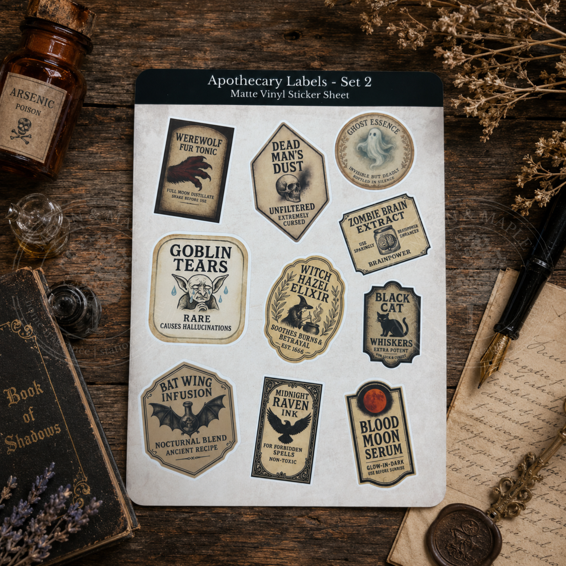 Sheet of apothecary labels with vintage-style designs on a wooden surface.
