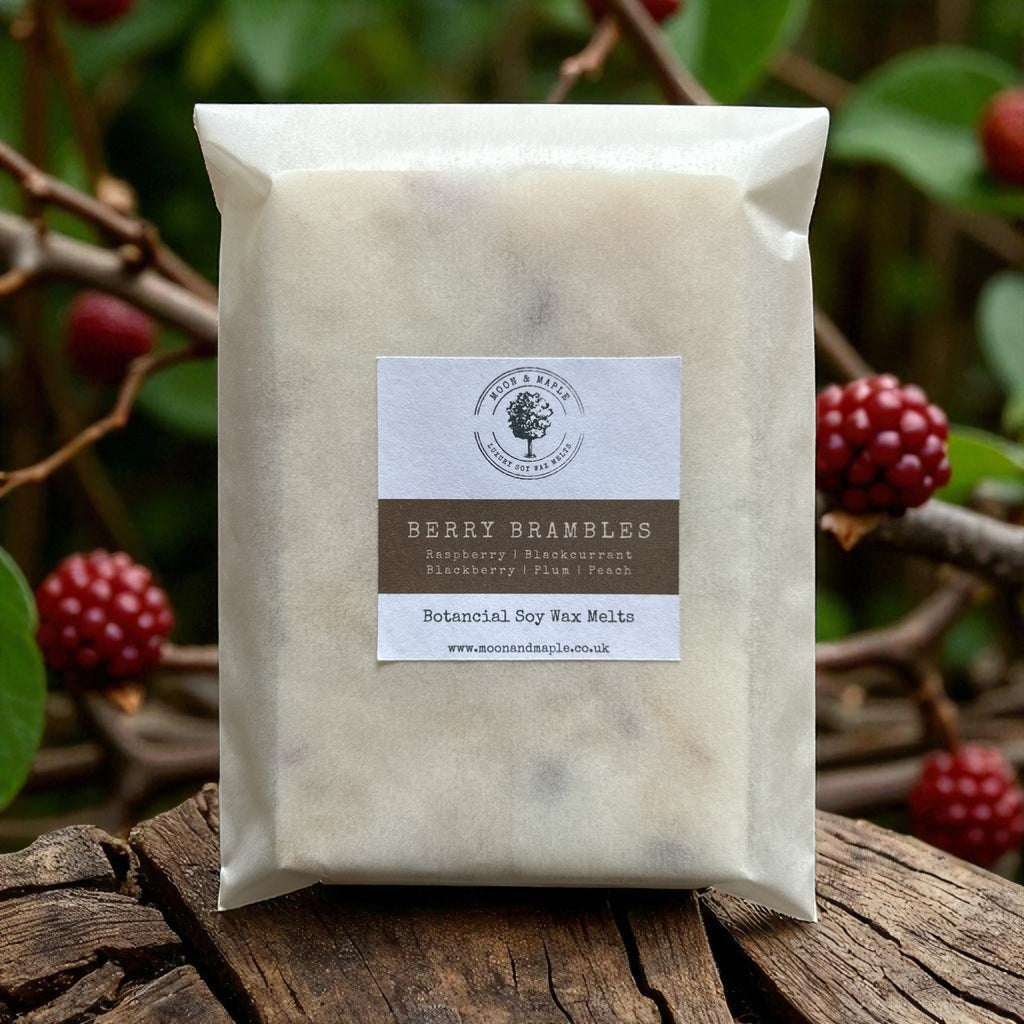 Pack of berry brambles wax melts on a wooden surface with berries in the background