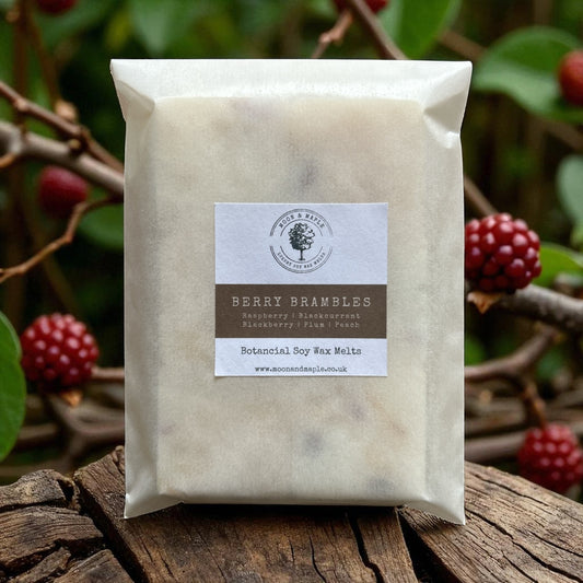 Pack of berry brambles wax melts on a wooden surface with berries in the background