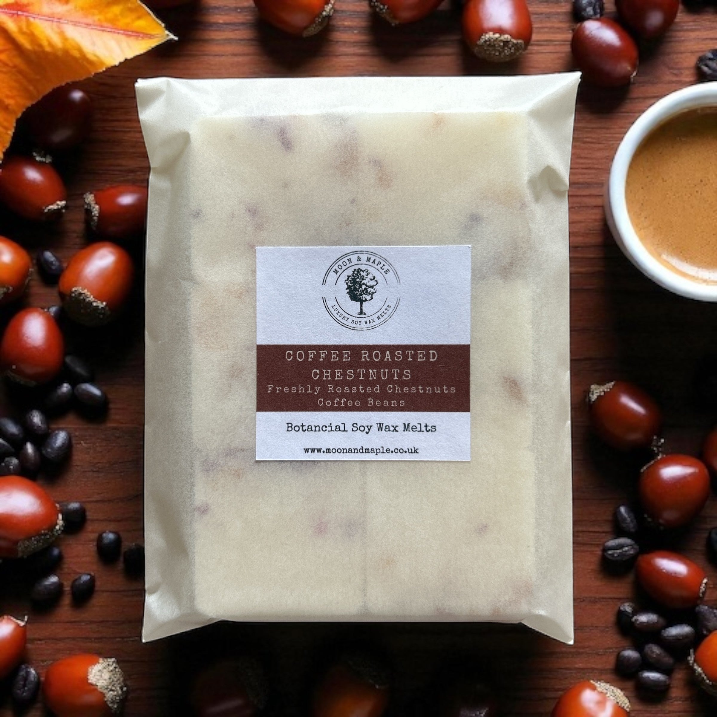 Packaged coffee roasted chestnuts wax melts with a label on a wooden surface with chestnuts and a cup of coffee.