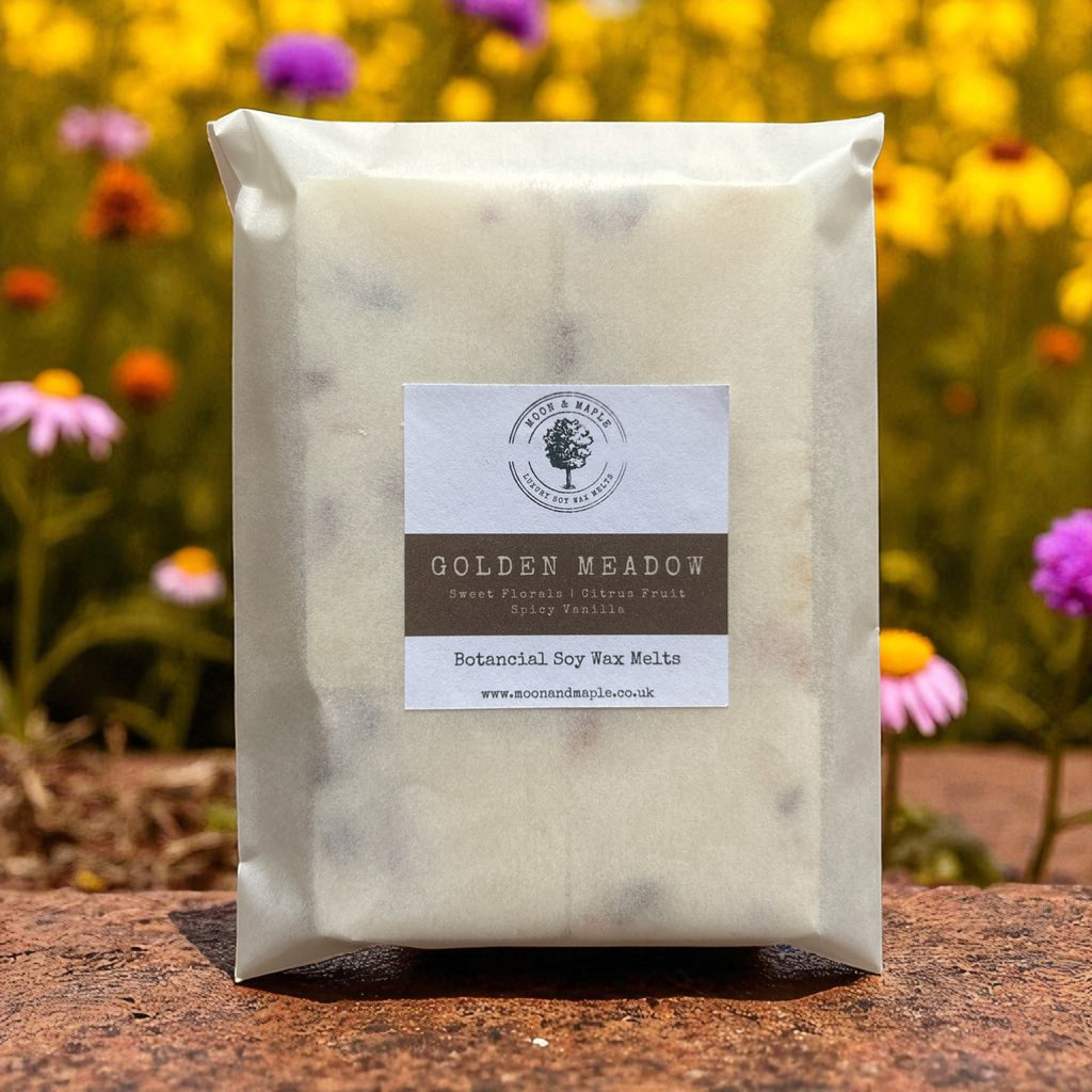 Packaged soy wax melts with a label against a natural background with flowers