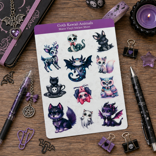 Sheet of goth kawaii animal stickers on a wooden surface with stationery items.