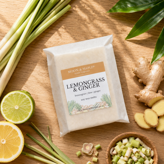 Moon & Maple Lemongrass & Ginger candle on a wooden surface with lemongrass, ginger, and lime.