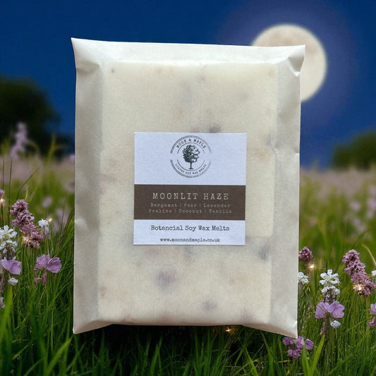 Packaged wax melts with a label on a background of a moonlit field with flowers.