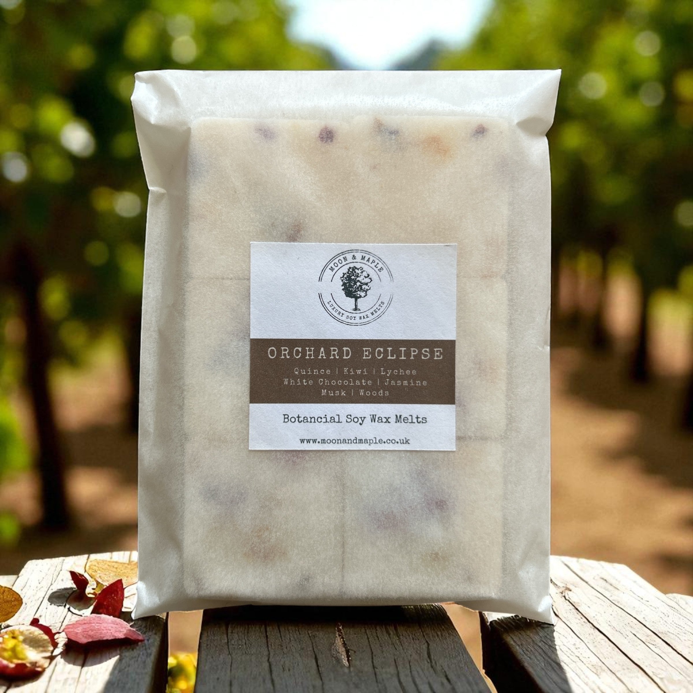 Packaged product labeled 'Orchard Eclipse' on a wooden surface with a natural background