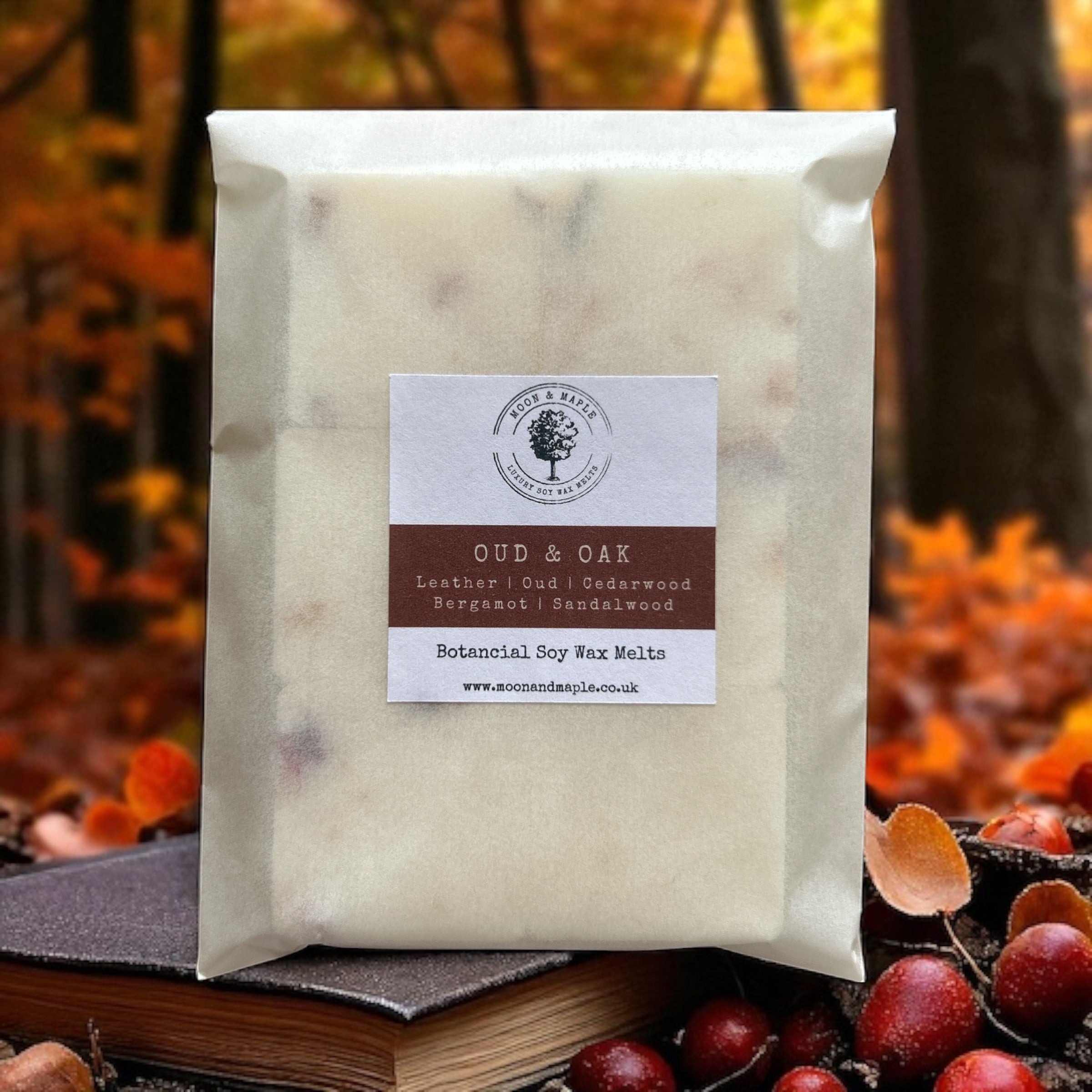 Packaged wax melts with a label on a blurred autumn background
