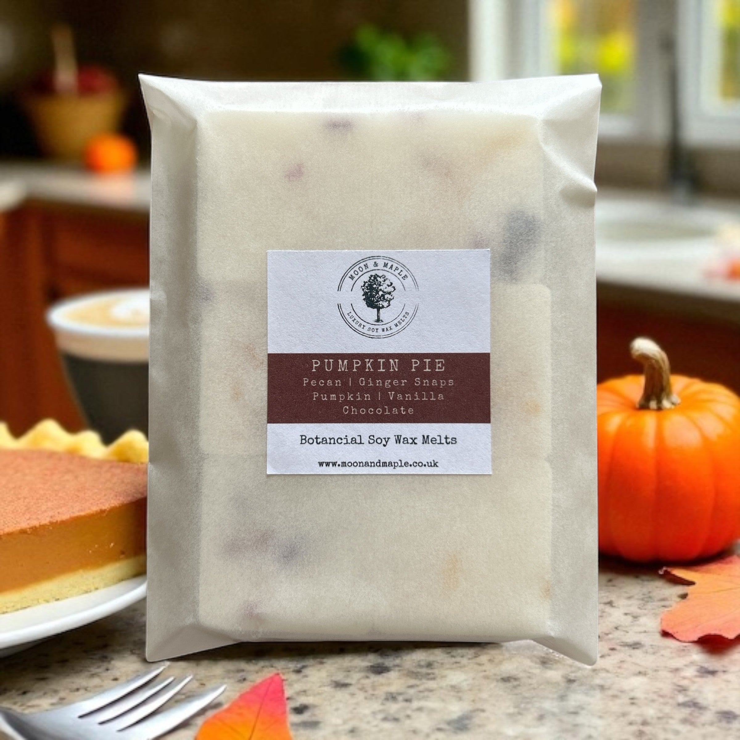 Packaged product labeled 'Pumpkin Pie' with a cake and pumpkin in the background