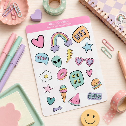 Sheet of colorful stickers with various designs on a desk with stationery items.