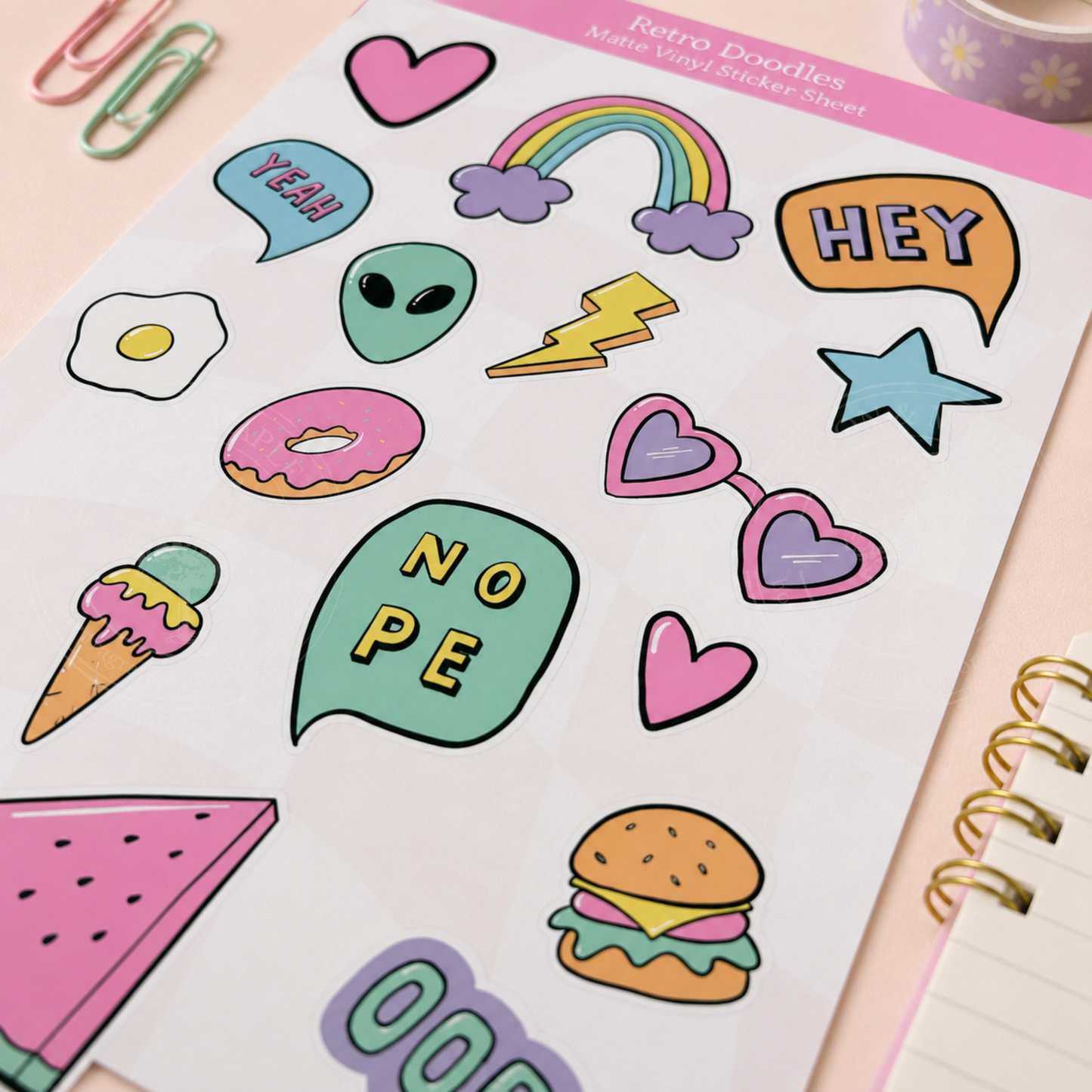 Sheet of colorful stickers with various designs including hearts, rainbows, and food items on a pink background.