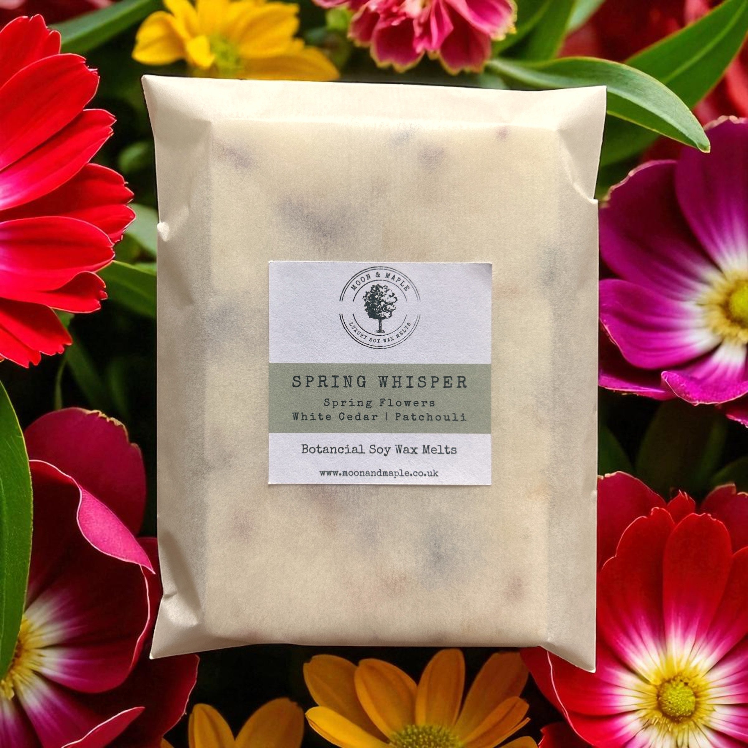 Pack of 'Spring Whisper' wax melts surrounded by colorful flowers